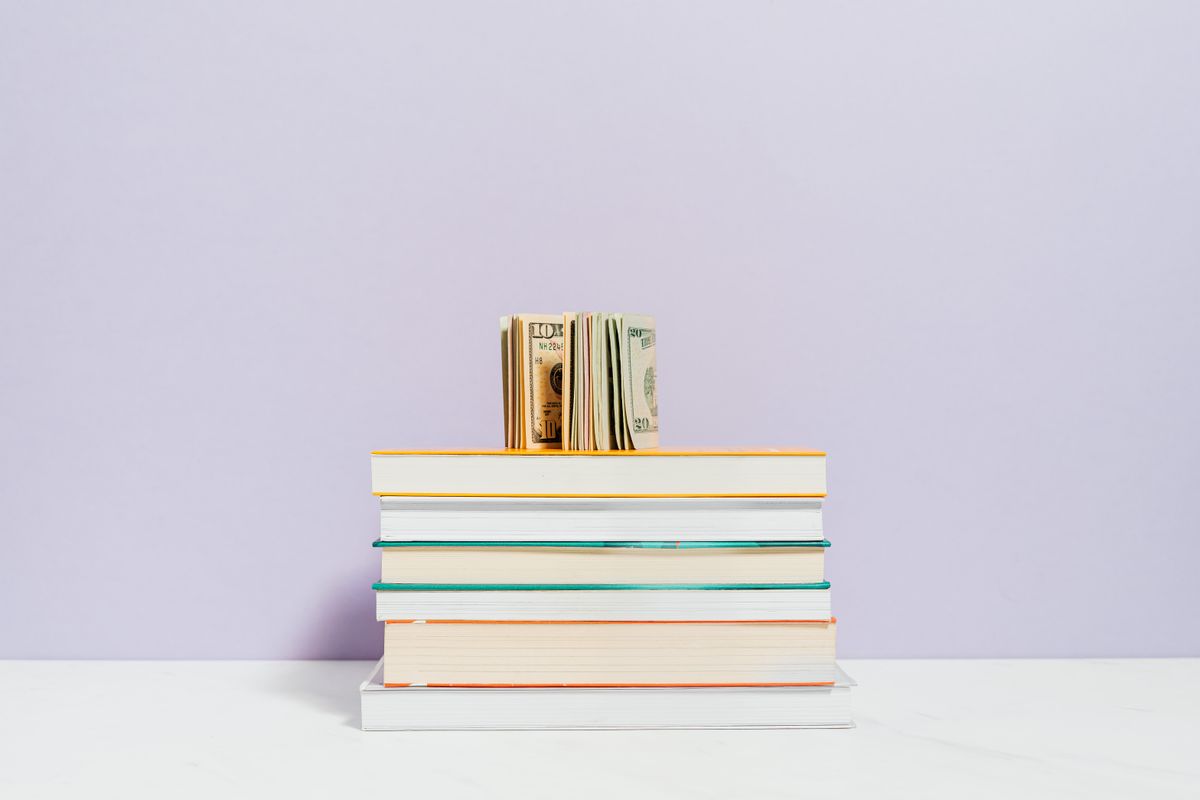 Cash resting on a stack of books